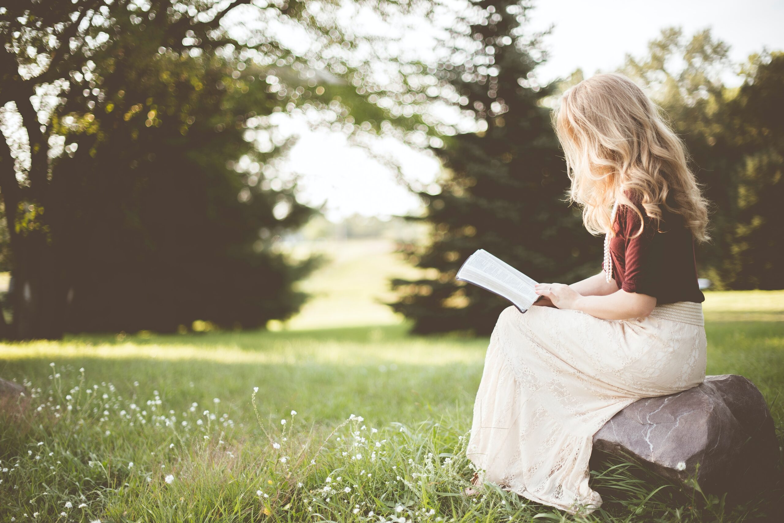 Photo of woman reading outdoors.