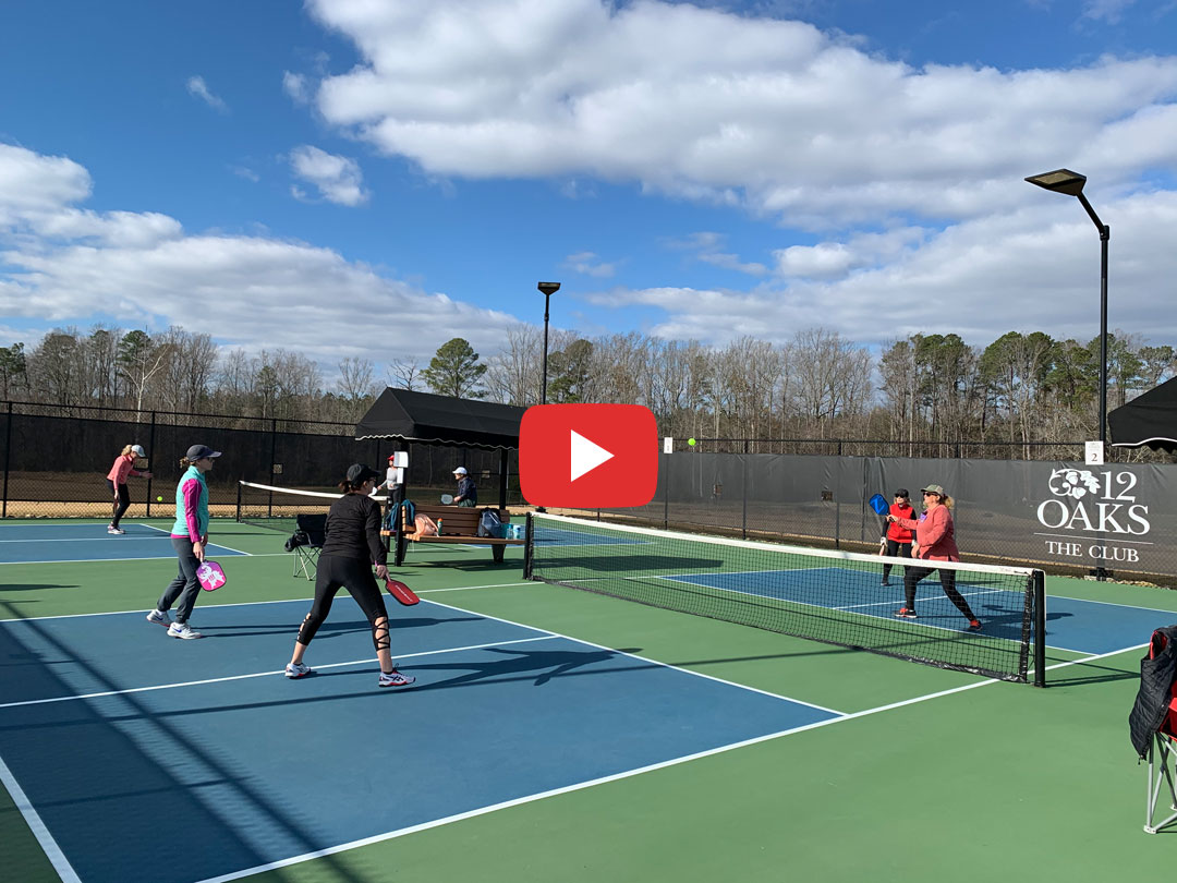 PickleballStillVid Image of people playing pickleball.