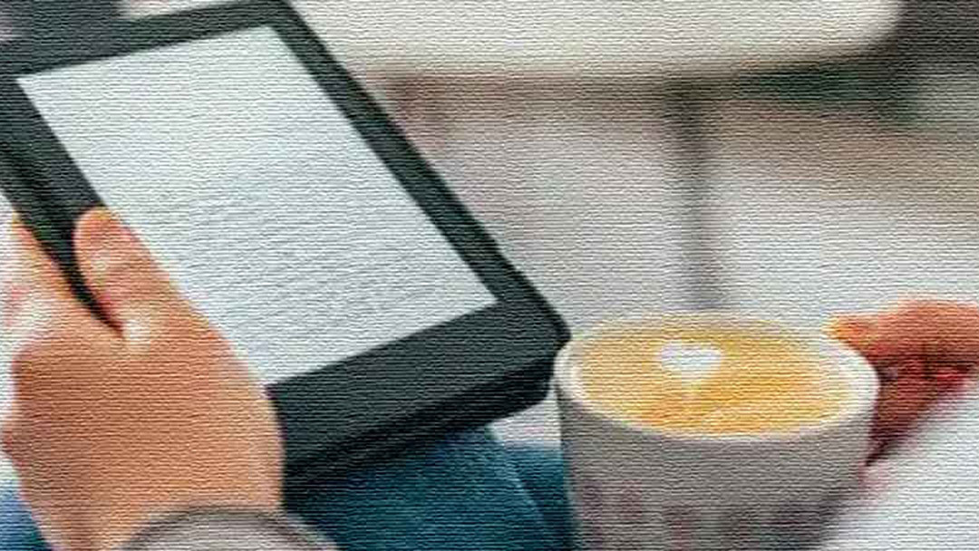 EReaderCoffee Image of woman reading while drinking coffee.