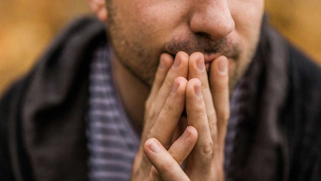 Photo of man with folded hands.