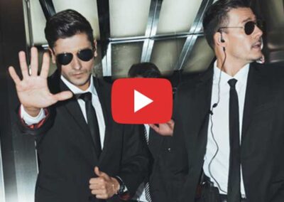 Image of men in dark suits and sunglasses.