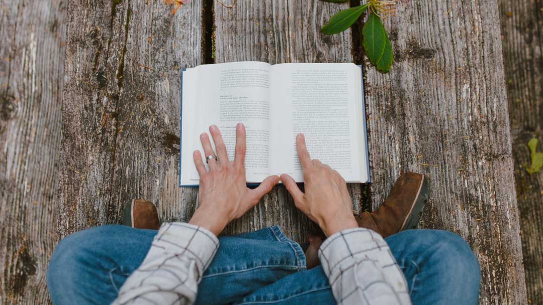 Photo of a girl reading a book.