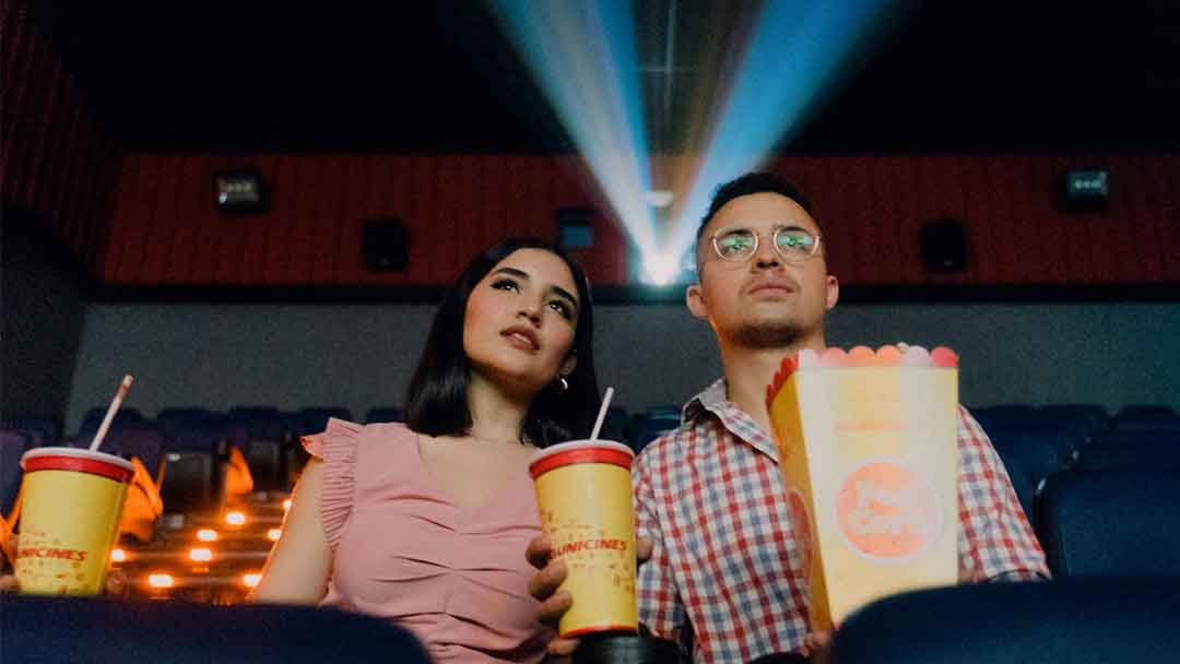 Photo of a man and woman in movie theater for blog post "Hidden Frames: 3 Magnetic Movies You Probably Missed in 2025"