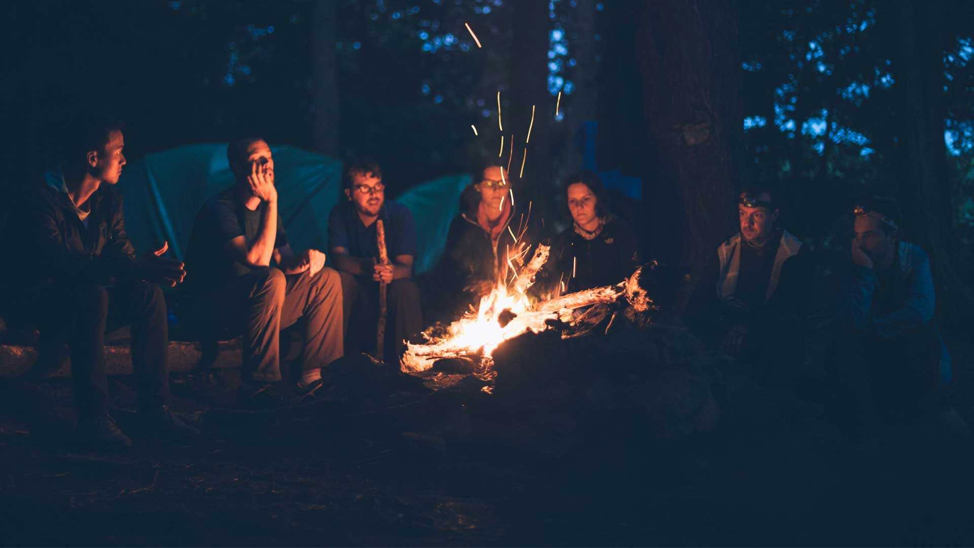 Photo of friends around a campfire for blog post “📚 What to Read Next — A Guide to Finding Stories That Actually Stay With You.’