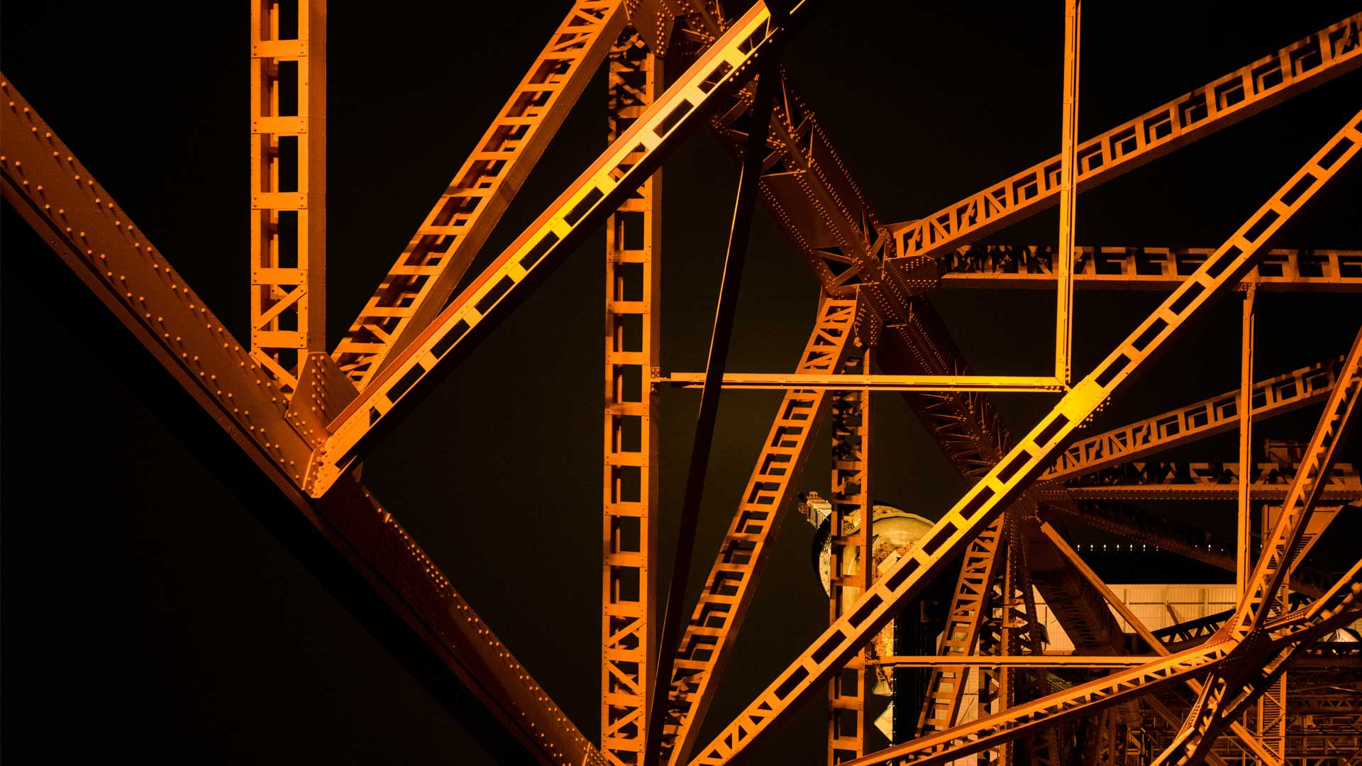 Photo of structural girders at night for blog post “✍️ How to Write a Novel That Actually Works — Structure, Story, and Creative Process.” Photo by Alain Pham on Unsplash