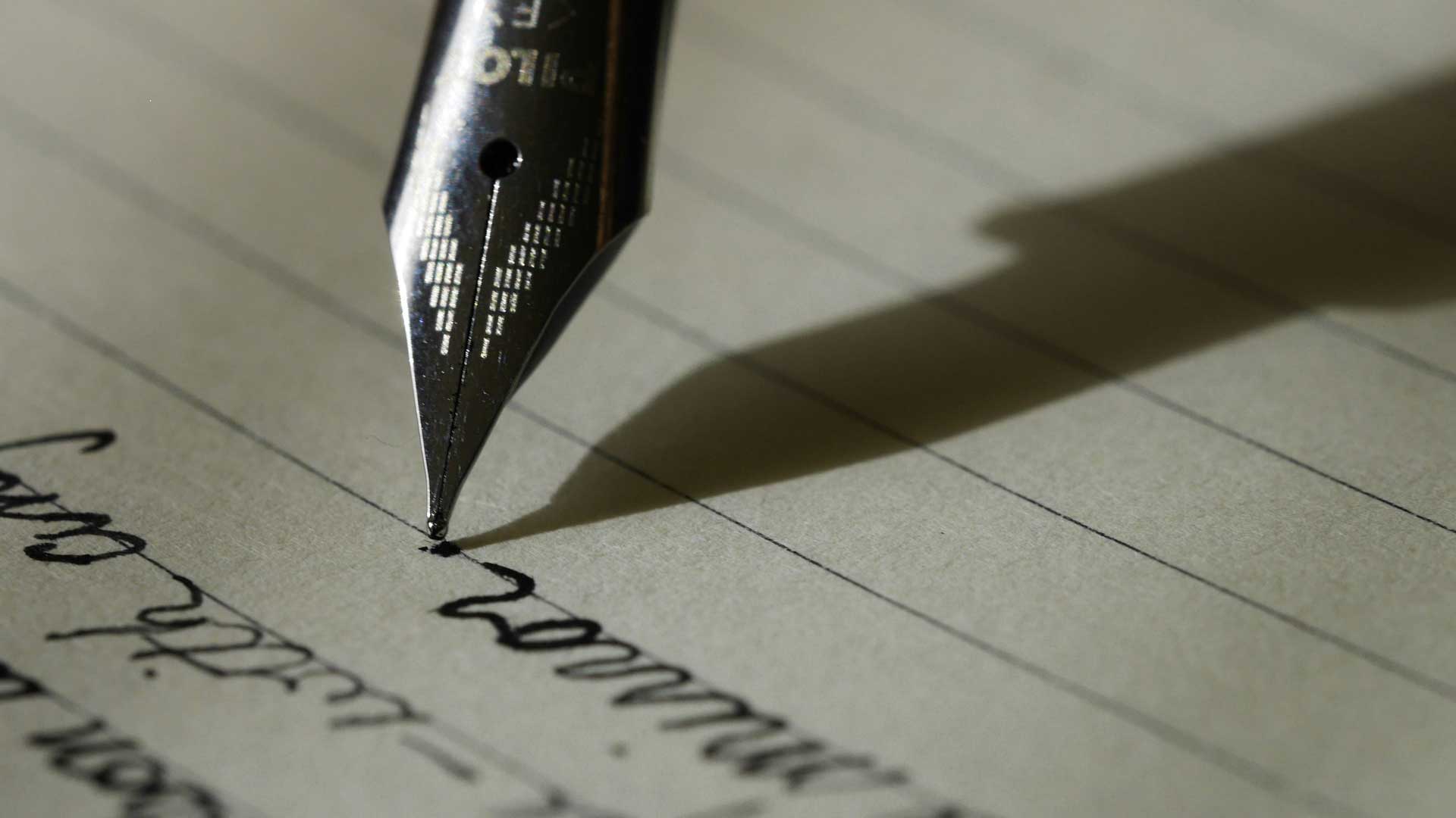 Photo of pen writing on paper with ink for blog post “✍️ How to Write a Novel That Actually Works — Structure, Story, and Creative Process” Photo by Aaron Burden on Unsplash