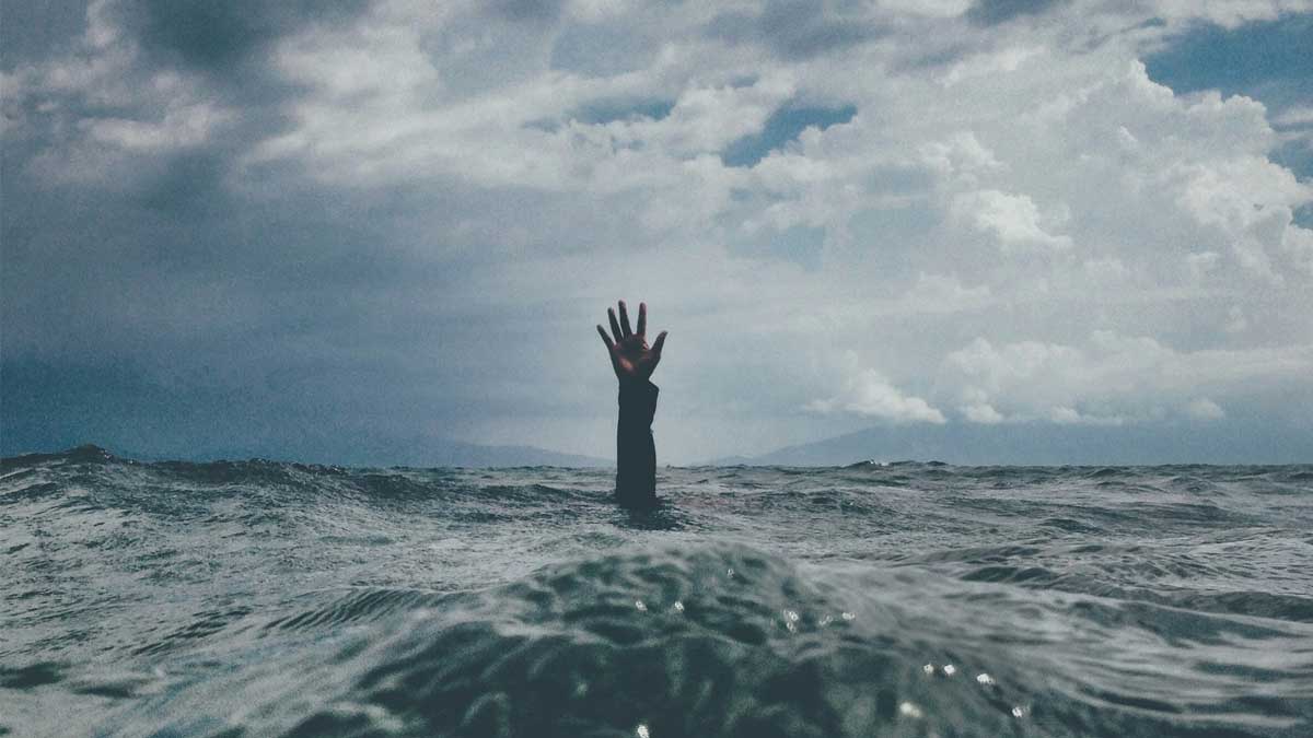 Image of a hand sticking out of the ocean by Photo by nikko macaspac on Unsplash