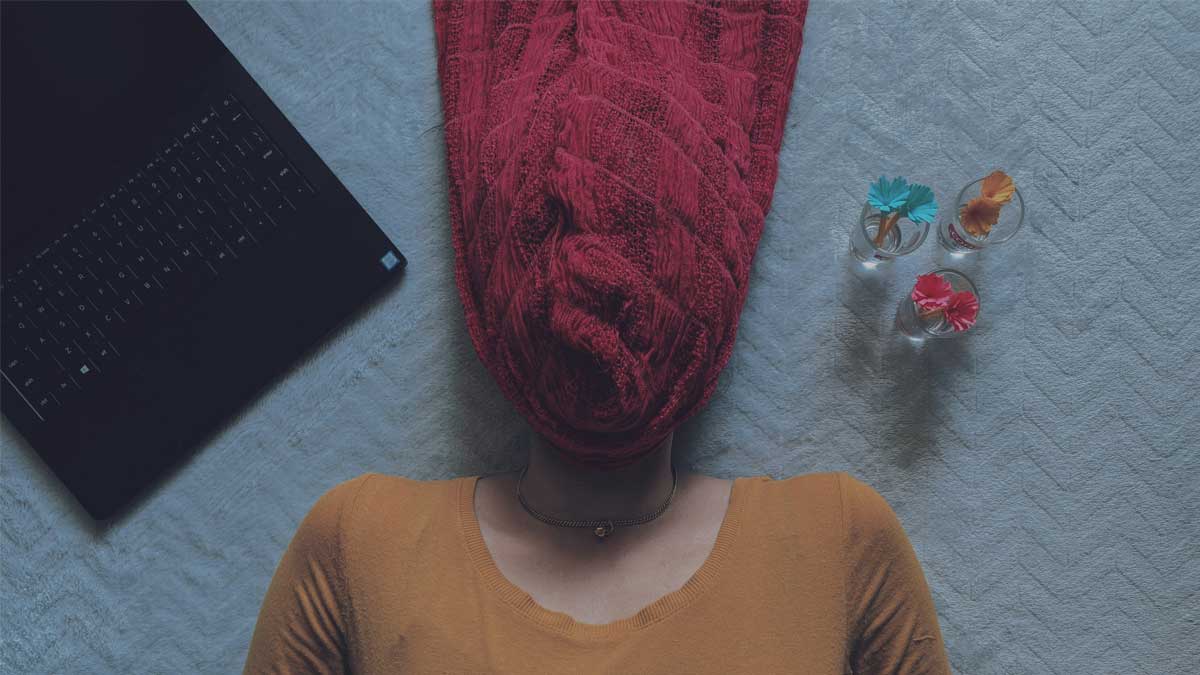 Image of a woman with a sweater over her head.