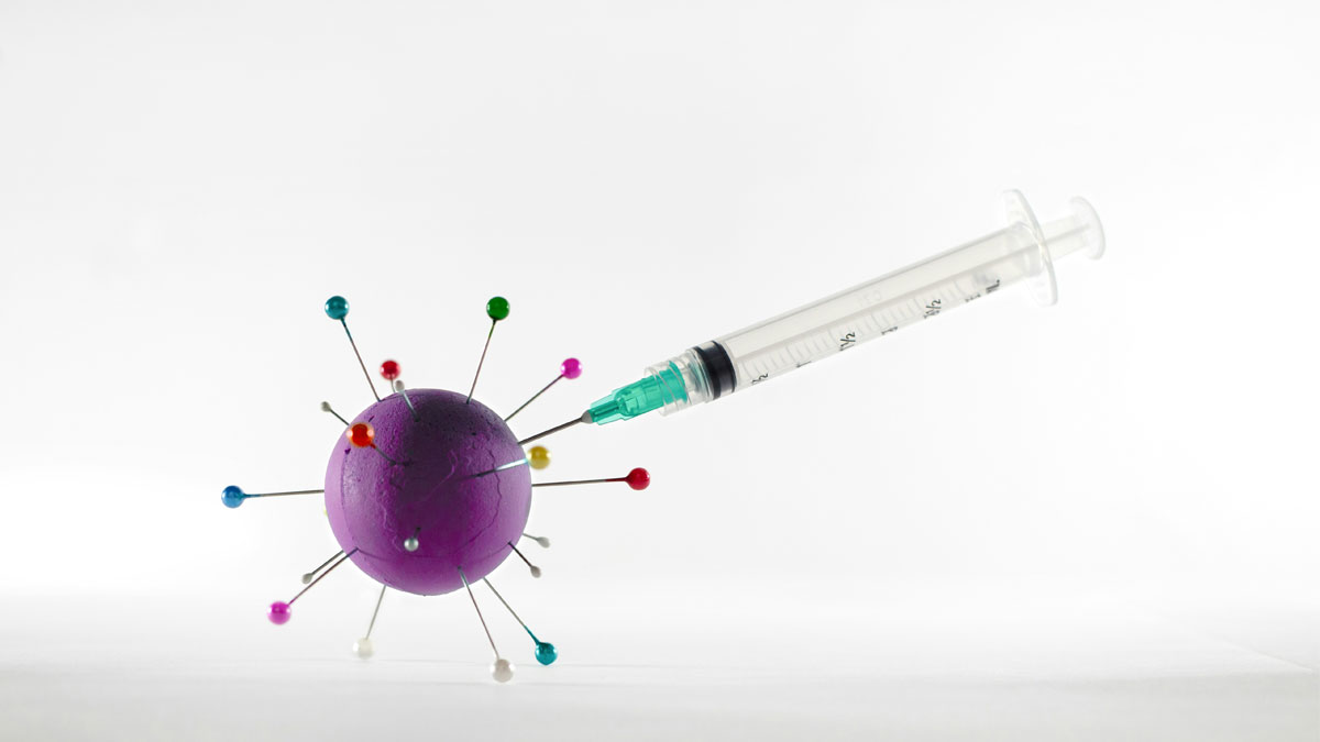 Image of a syringe and a pin cushion.