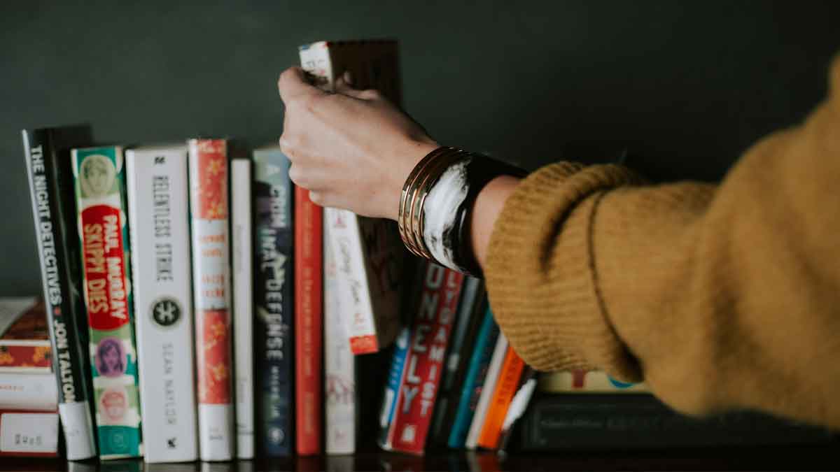PickingABook01 Image of a hand reaching for a book.